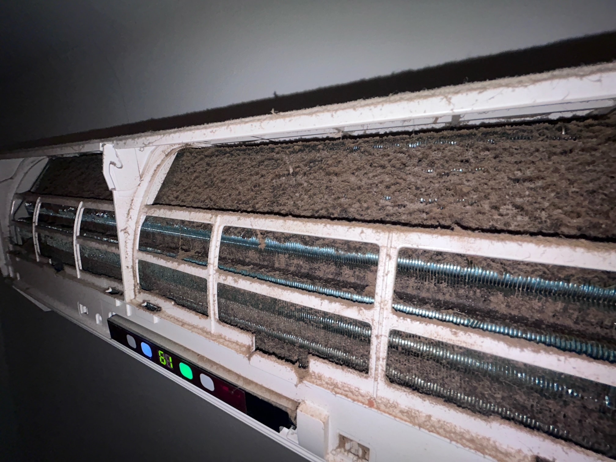 Mini-split interior with mold and dust buildup before cleaning