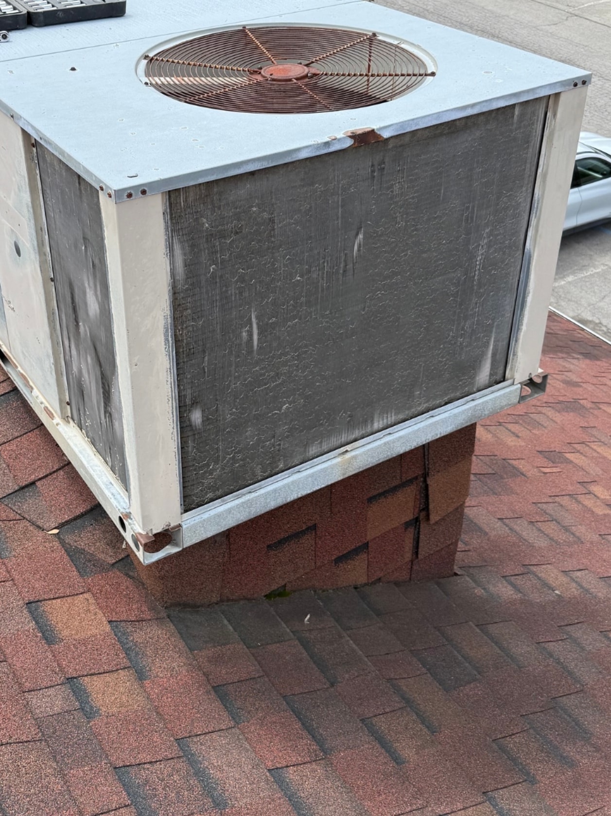 Neglected commercial rooftop HVAC unit before cleaning